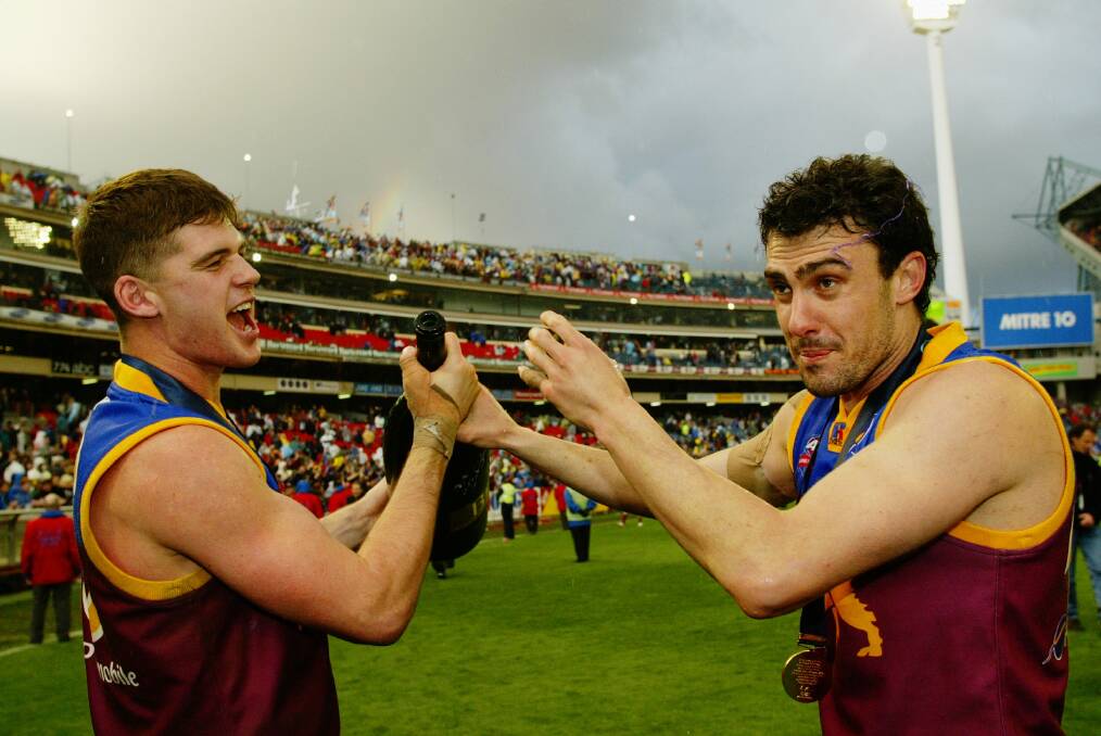 HAPPY DAYS: Jonathan Brown celebrates a Brisbane Lions' grand final win over Collingwood with teammate Nigel Lappin. The pair played in all three flags from 2001-03. Picture: Ray Kennedy
