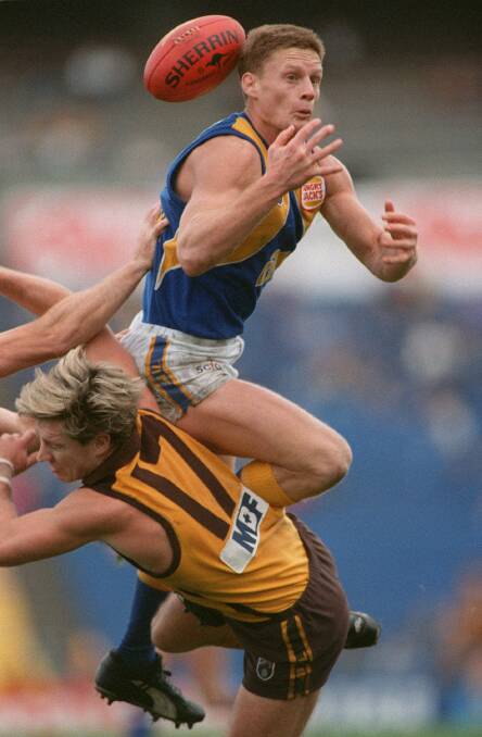 EAGLE SOARS: Guy McKenna during his AFL playing days with West Coast. He played in the Eagles' 1992 and '94 premierships.