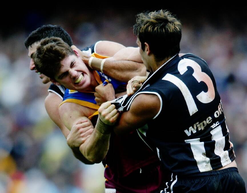 HANDS ON: Brisbane Lions centre half-forward Jonathan Brown in a tangle with Collingwood players during the 2003 AFL grand final.