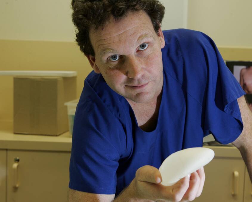 Plastic surgeon Ian Holten holding onto a breast implant used for reconstruction and enlargements. Picture: Leanne Pickett 