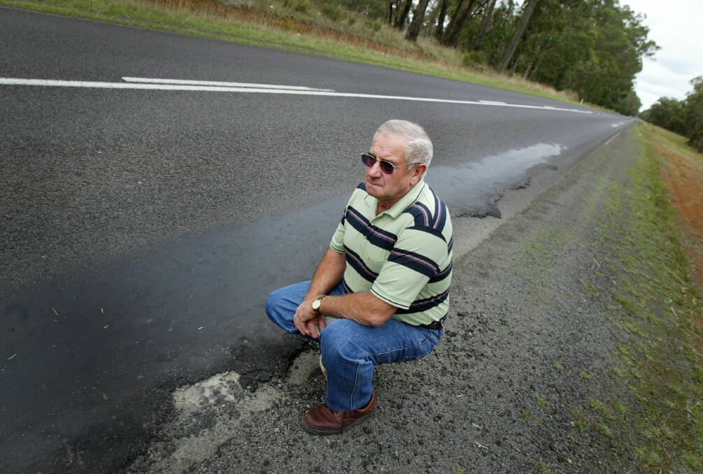 Road safety campaigner: Bruce Couch beside the damaged Cobden -Warrnambool road in 2007 in his role as Moyne Shire councillor.  