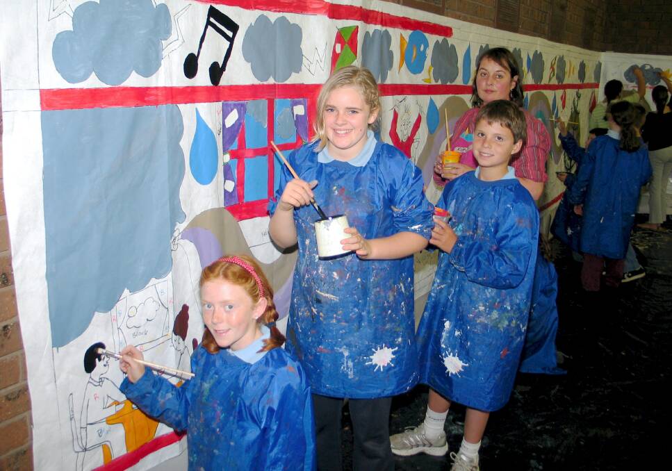 HANDS ON: Students Emily Forrest, Georgina Lenehan and Jake Hetherington work with artist Kathryn Weatherly on a mural for the very first Port Fairy Winter Weekends in 2007.