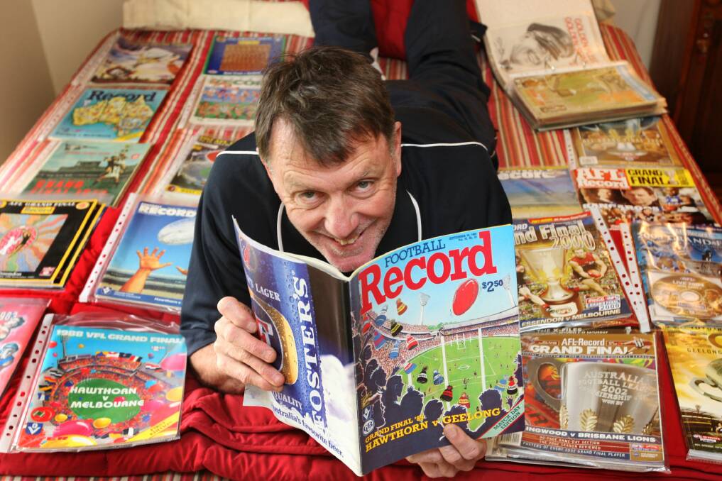 TRADITION: Alan Thompson, in 2008, surrounded by his dozens of pristine condition football records from almost ever Grand final of the last 40 years. He has kept up a streak of attending grand finals.