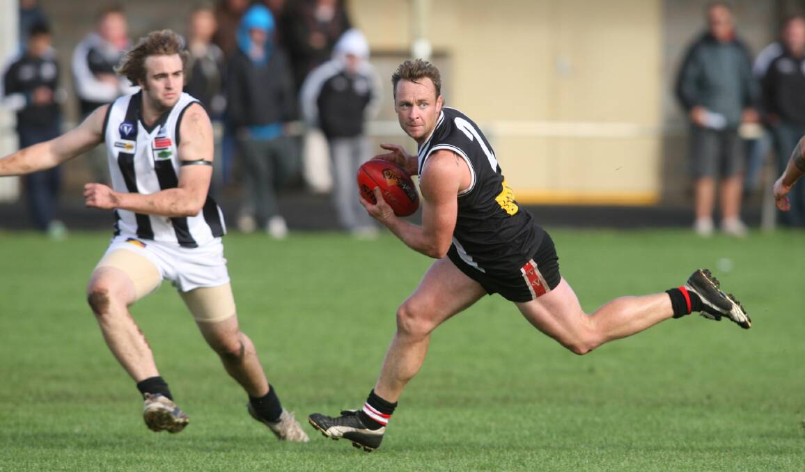 On the ball: Former Koroit Football Netball Club premiership player Jarrod Gleeson is fired up about the the town's imminant Irish Festival. He is pictured playing against Camperdown's Nick Bateman in 2009.
