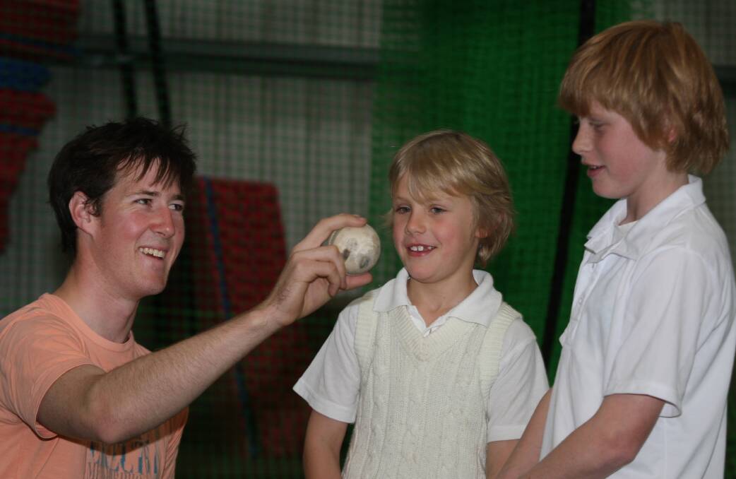FLASHBACK: Brierly division one player Niall Easterbrook teaching Ollie King ,8, and Nick King ,11, how to hold a cricket ball in 2009. 