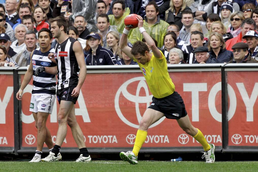Big game: Shaun Ryan bounces the ball in the 2011 grand final between Collingwood and Geelong. Picture by PAUL ROVERE / THE AGE