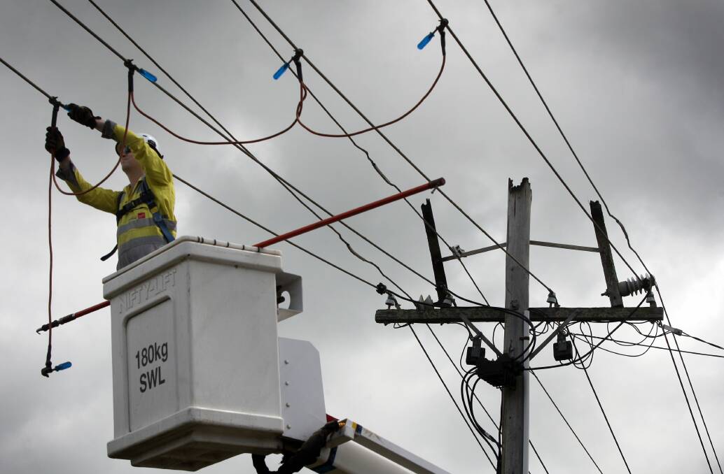 Repairs: A Powercor worker busy after a previous power pole fire in Warrnambool's Bromfield Street.
