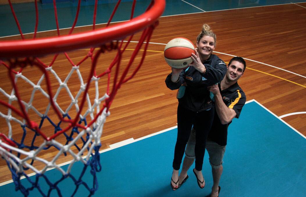THROWBACK: Canberra Capitals player Nicole Hunt and Canberra Gunners player Alex Gynes clowning around before training at the Belconnen Basketball Stadium. The two are now married and have two children. 