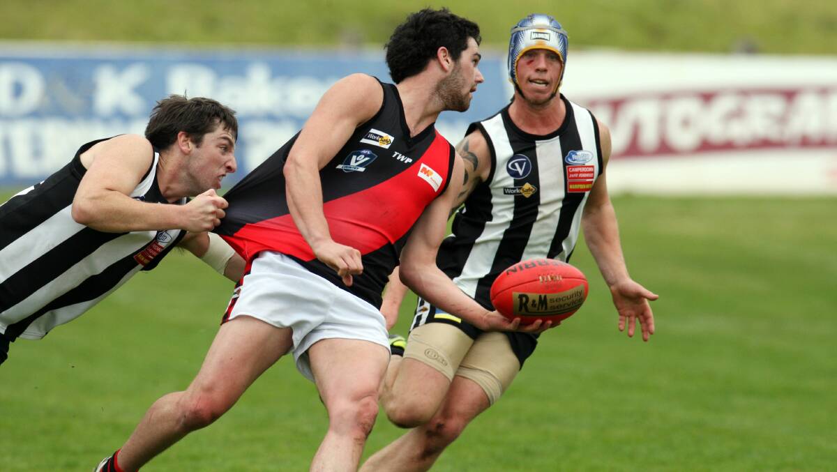 FREE HANDS: Eddie Lucas tries to tackle Brody Mahoney in the 2013 Anzac Day game.