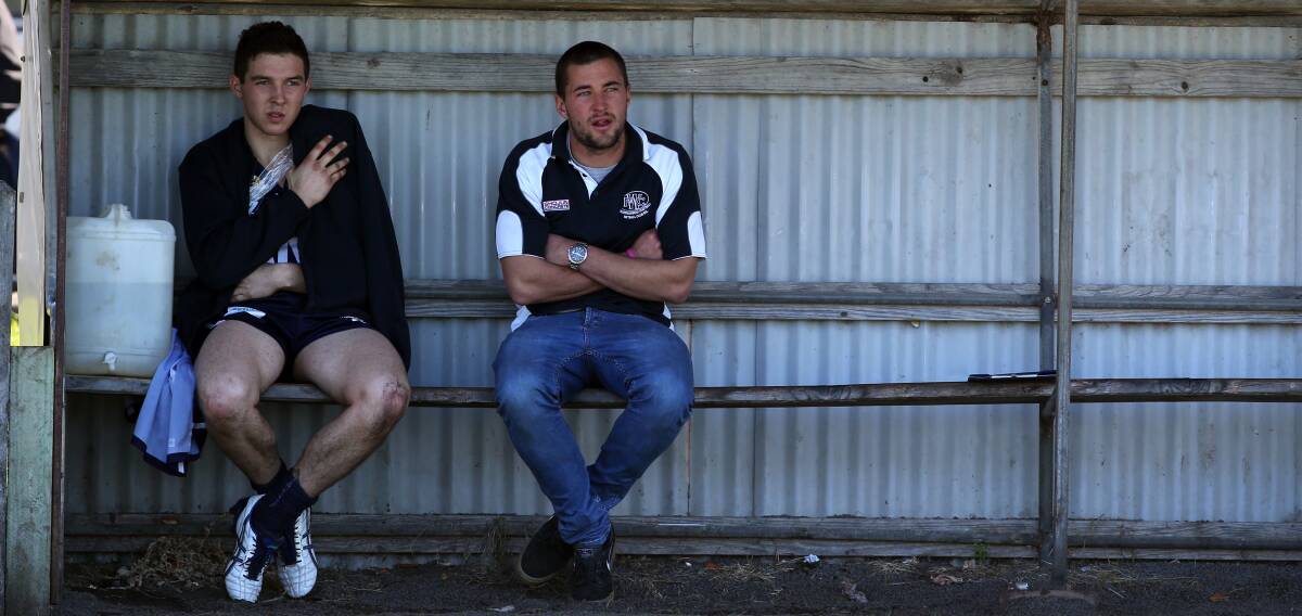 SIDELINED: Bell sits on the bench with Darcy Graham during the 2014 semi-final when he broke his collarbone. 