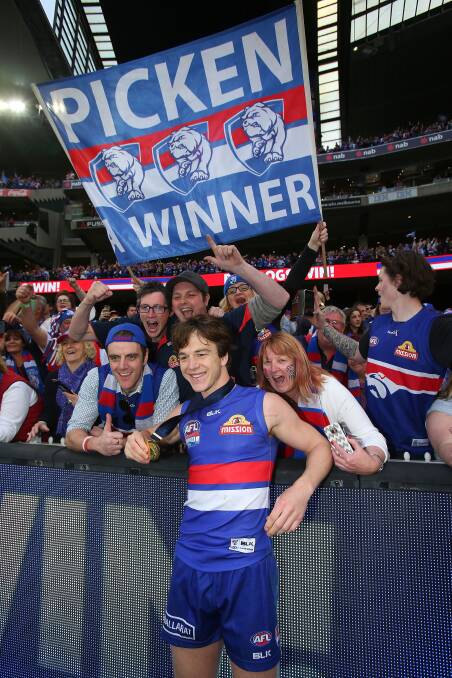 PRIZE: Liam Picken shares the joy of his premiership medal with Western Bulldogs fans after the 2016 grand final win. His father Billy was among the crowd that day.
