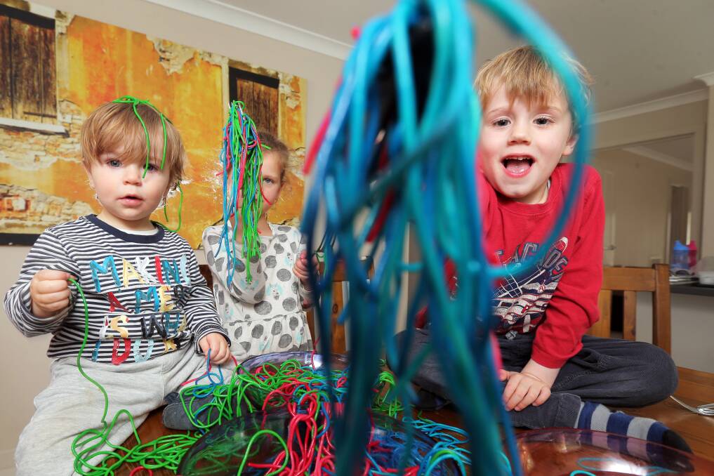 Messy play: Humphrey Horwill, 15months, Violet Brennan, 5, and Felix Horwill, 5, are getting prepared for the Warrnambool Toy Library Messy Play Day in 2017. Picture: Rob Gunstone