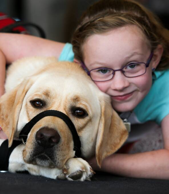 Responsive: Felicity Baker with her epilepsy response dog Ernie that she gained with the help of City Memorial Bowls Club's bingo sessions. Picture: Rob Gunstone