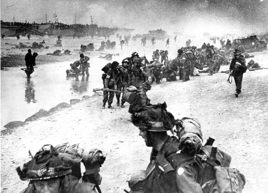 Landing day: British troops move on the Normandy shore from their landing craft on June 6, 1944 during the D-Day invasion of German occupied France during World War II.  Picture: AP