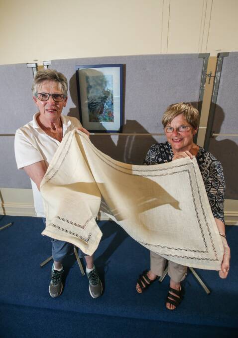 Historic display: Victorian Embroiderers' Guild south-west branch members Judy Miller and Lorraine Blackmore prepare for the weekend exhibition. Picture: Amy Paton