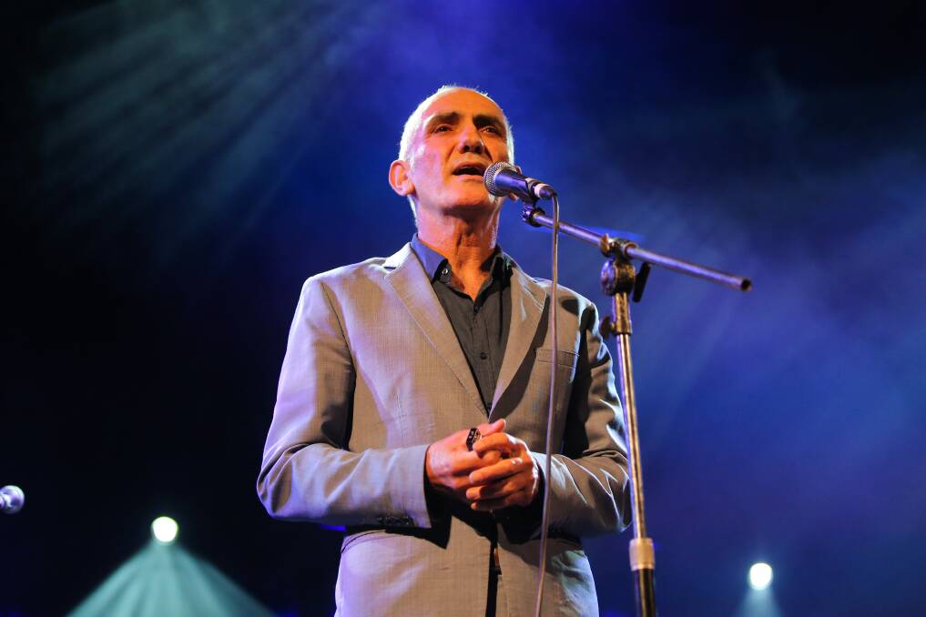 LISTEN UP: Paul Kelly cradles his harmonica and talks to the crowd during his show on stage three Saturday night. Picture: Morgan Hancock
