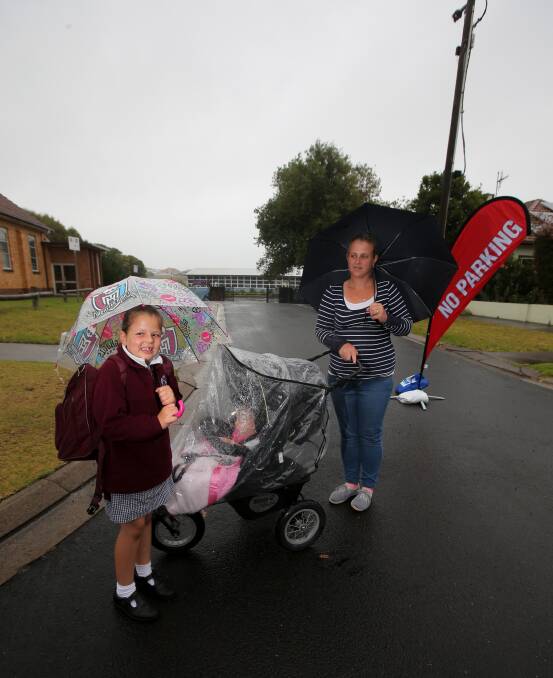 Fury: Gabriell Hoare, 7, sister Dominique Ligthart, 1, and mum Amanda Ligthart are worried about child safety at drop-offs. Picture: Rob Gunstone