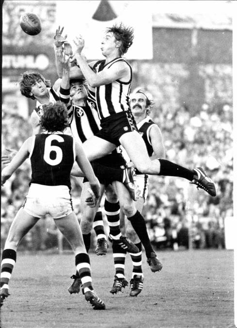 Billy Picken flies high above a pack during a match against St. Kilda at Victoria Park in 1980. 