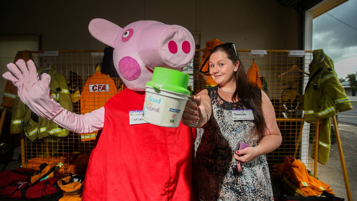 Dig deep: Port Fairy's Carlee Knights, dressed as Peppa Pig, tin rattling with sister Sonia for the Good Friday Appeal. Picture: Amy Paton