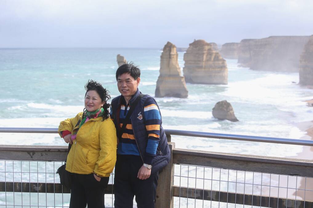 Iconic snap: Tourists take photos with the Twelve Apostles. Picture: Amy Paton