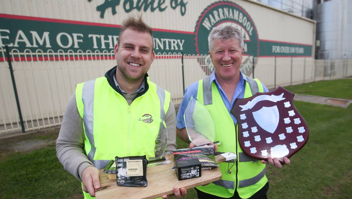 Award winners: Warrnambool Cheese and Butter's David Mellor and Wayne Davis with  some of the cheeses that won national awards for the company last week. Picture: Morgan Hancock