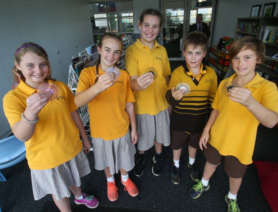 New craze: Warrnambool Primary School students Kacey Carman, 12, Layne Porter, 11, Breanna Coppin, 11, Ryan Welch, 10, and Cooper Phillpot, 10, all playing with their fidget spinners. Picture: Morgan Hancock 