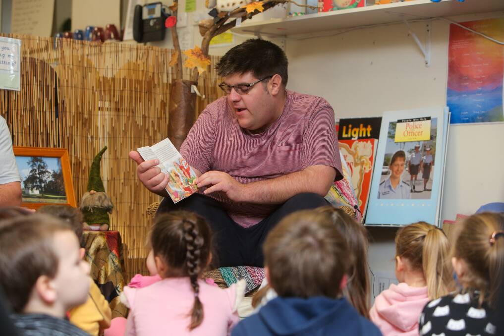 Story time: Chris Gstrein, who has autism, reads to students at Warrnambool Central Kinder, as part of its connections to the community program. Picture: Rob Gunstone