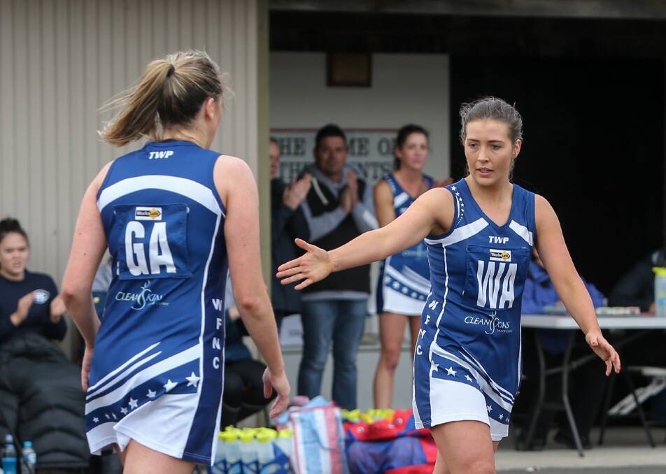 STANDING TALL: Warrnambool netballers Amy Wormald (left), and Mahni Wright were among the Blues' best in Saturday's win over Portland.