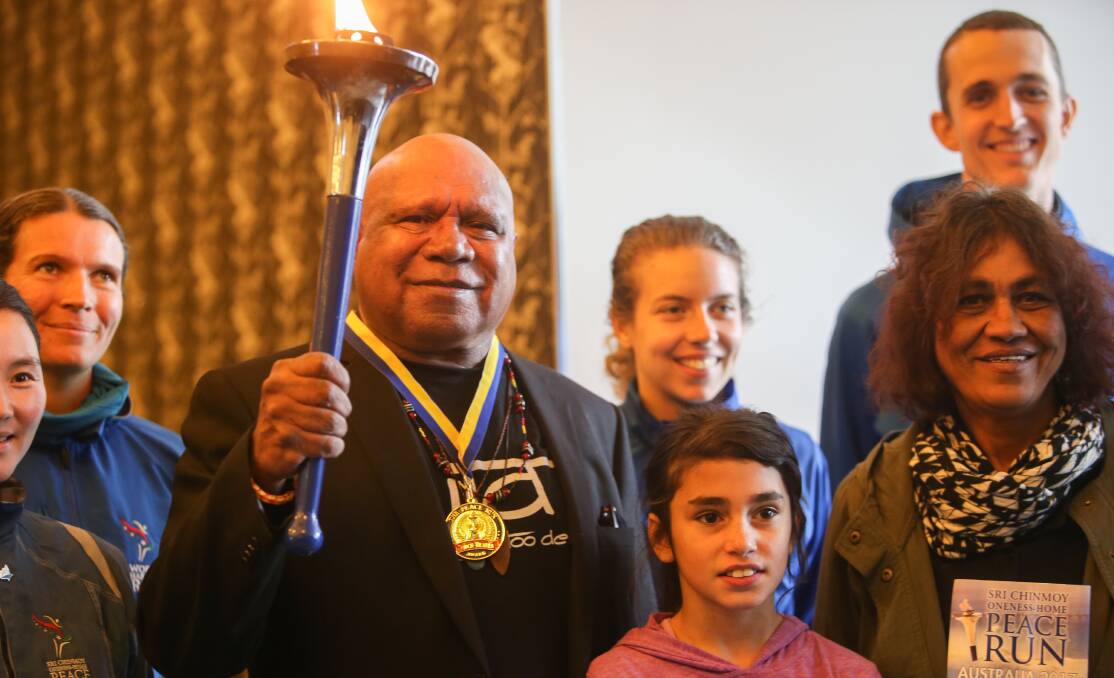 UNITED: Archie Roach with participants from the peace run during their stopover in Port Fairy on Wednesday. Picture: Amy Paton