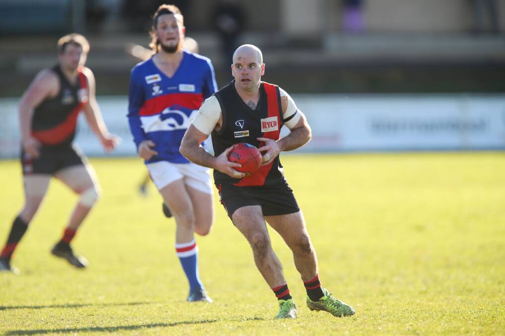 TEAM-FIRST APPROACH: East Warrnambool's Danny Chatfield looks for teammates to pass to during his playing days at the Bombers. Picture: Morgan Hancock