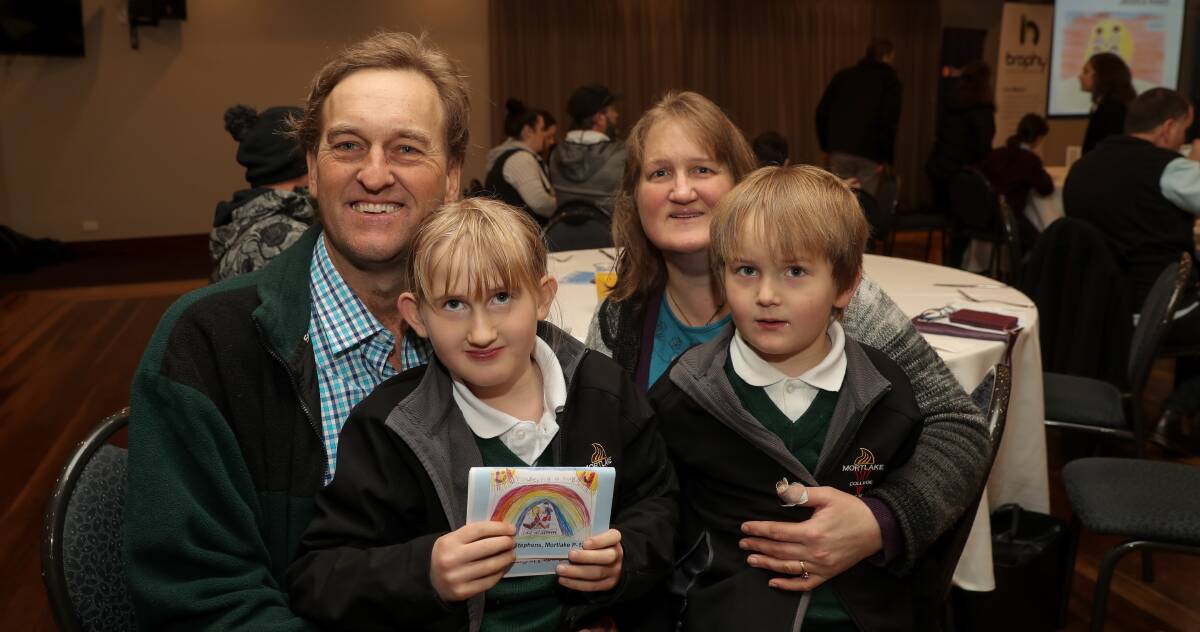 Hugs and rainbows: Winner in the prep to grade 2 father of the year Greg Stephens and daughter Grace Stephens, 8, made the trip from Mortlake to attend the 2017 father of the year awards. Picture: Rob Gunstone