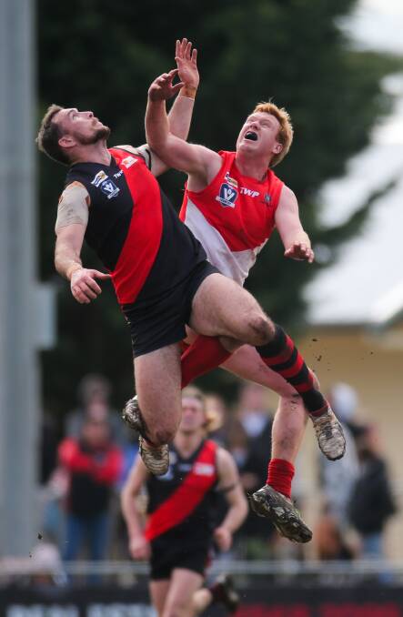 RISING UP: Cobden coach Levi Dare competes with South Warrnambool ruckman Manny Sandow. Pictures: Morgan Hancock