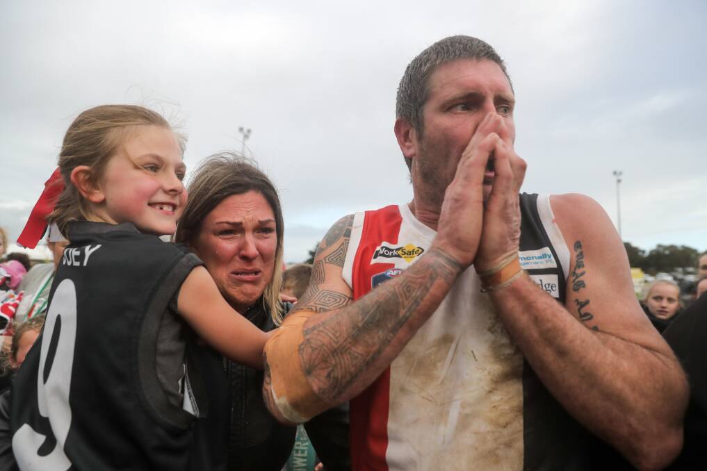 Roller coaster: An emotional Koroit star Joe McLaren shares a special moment with his wife Sarah and daughter Ella after the Saints won the premiership last year. Picture: Rob Gunstone