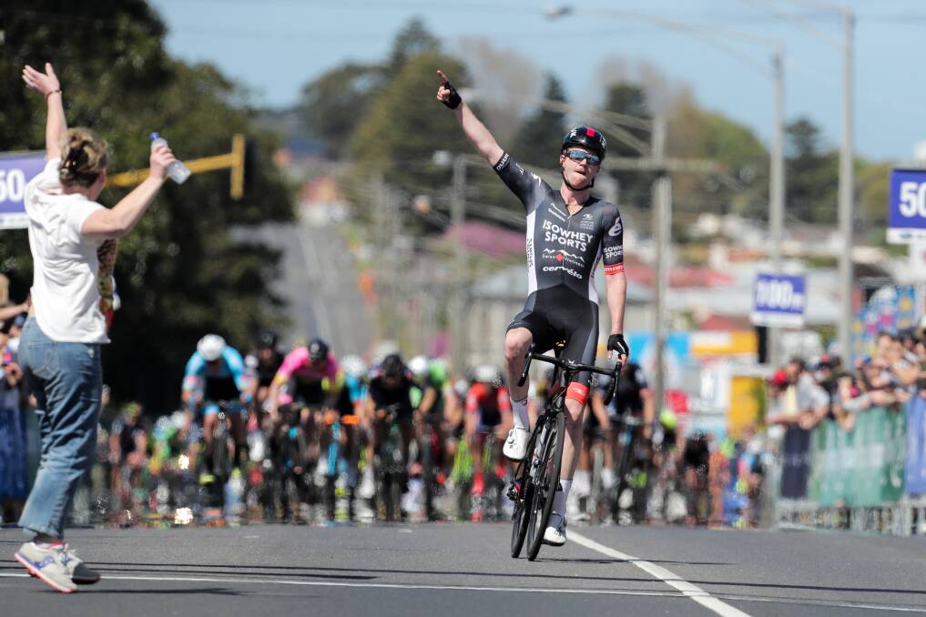 HISTORIC: Nathan Elliott celebrates as he crosses the finish line to become the first rider to win the Melbourne to Warrnambool two years running, as his mum Sofi jumps onto the road in ecstasy. Picture: Rob Gunstone