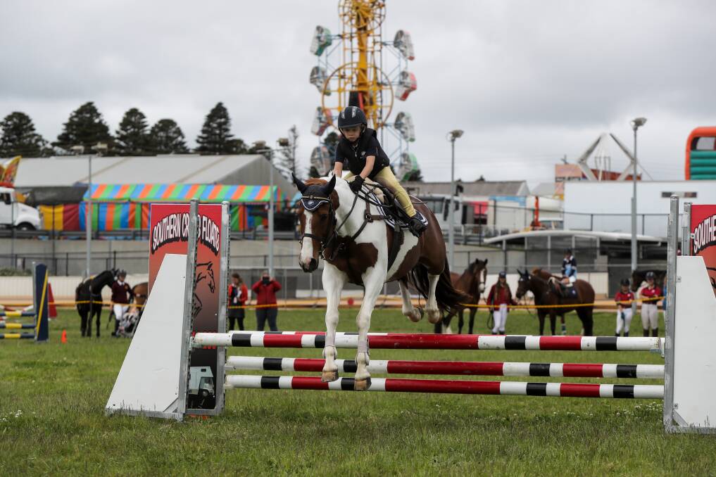 BACK TO ITS ROOTS: Young rider Harley McNaughton, 7, from Pakenham, guides Mai Tai showjumping around the course at the Warrnambool Show. Picture: Rob Gunstone