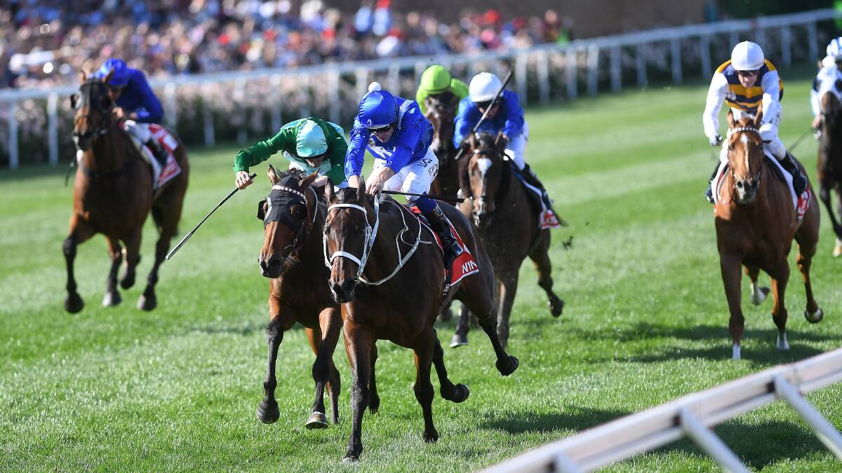BATTLE READY: Hugh Bowman rides Winx (third from left) to victory in the 2017 Cox Plate ahead of Humidor, ridden by Blake Shinn (second from left). They will race against each other again on Saturday. Picture: AAP