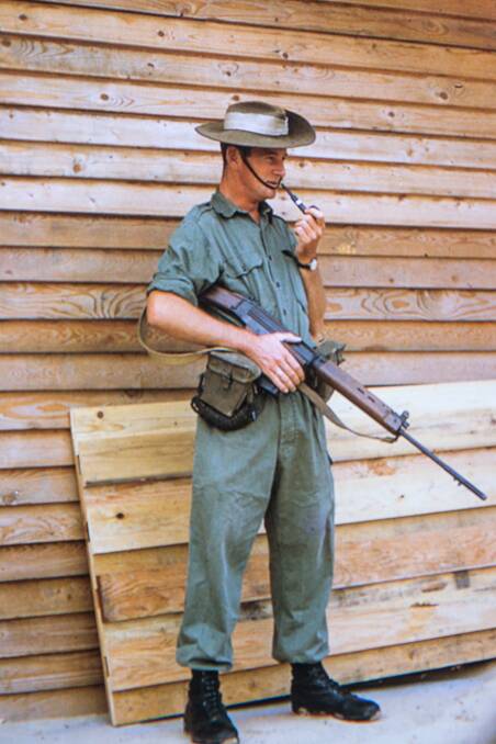 Standing guard: John Miles pictured in Vietnam in the 1960s. Mr Miles spent 10 months at war, serving as a driver in the transport corps.