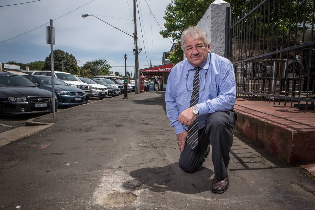 UPGRADE NEEDED: Moyne Shire Council mayor Jim Doukas assesses the state of the footpath in Bank Street, Port Fairy. Picture: Christine Ansorge