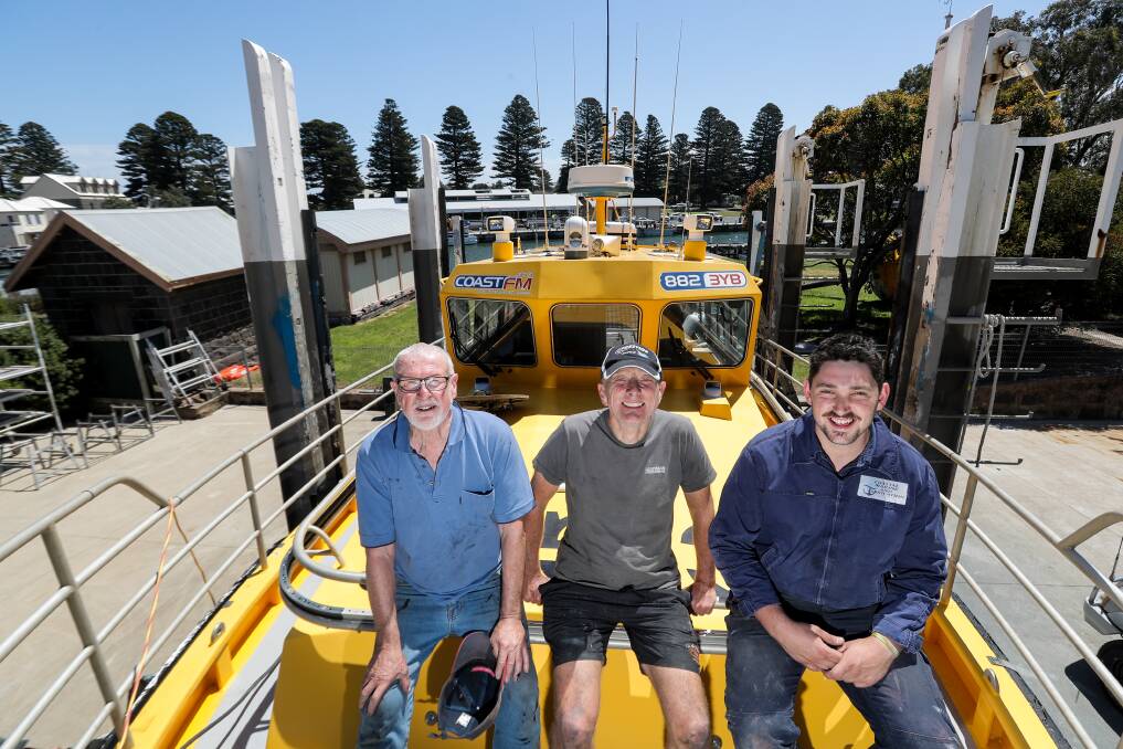 Coast Guard Warrnambool commander Allan Wood, skipper Keith Prest and Brandon Dodoro, from Coastal Marine and Fabrication, are getting the boat ready for the summer season with the help of volunteers. Picture: Rob Gunstone