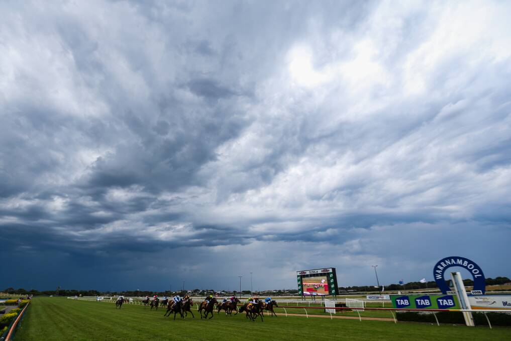 Horses compete during race 3, before the rain began. Picture: Morgan Hancock