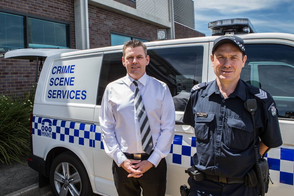 On the job: Detective Senior Sergeant David Reither and Sergeant Jason Puschenjak with a crime scene services van. Picture: Christine Ansorge