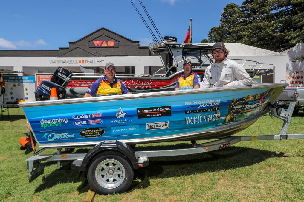 Raffle prize: Sam Powell, Grant Bellman and  Corey McLaren in the boat which was won by Terang's Troy Anderson on Sunday. Picture: Rob Gunstone