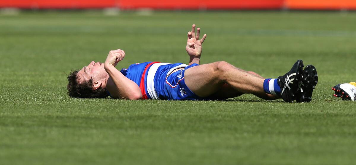 Hamilton export Liam Picken lays motionless on the ground after being knocked out in a pre-season game at Ballarat in 2018. He retired from the game earlier this year because of impacts from concussion. Picture: Wayne Ludbey