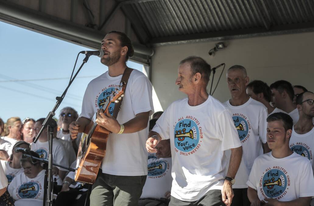 IN FULL SONG: Tom Richardson leads the all-abilities Find Your Voice choir at the Port Fairy Folk Festival in March. The choir has received funding so it can continue. Picture: Rob Gunstone