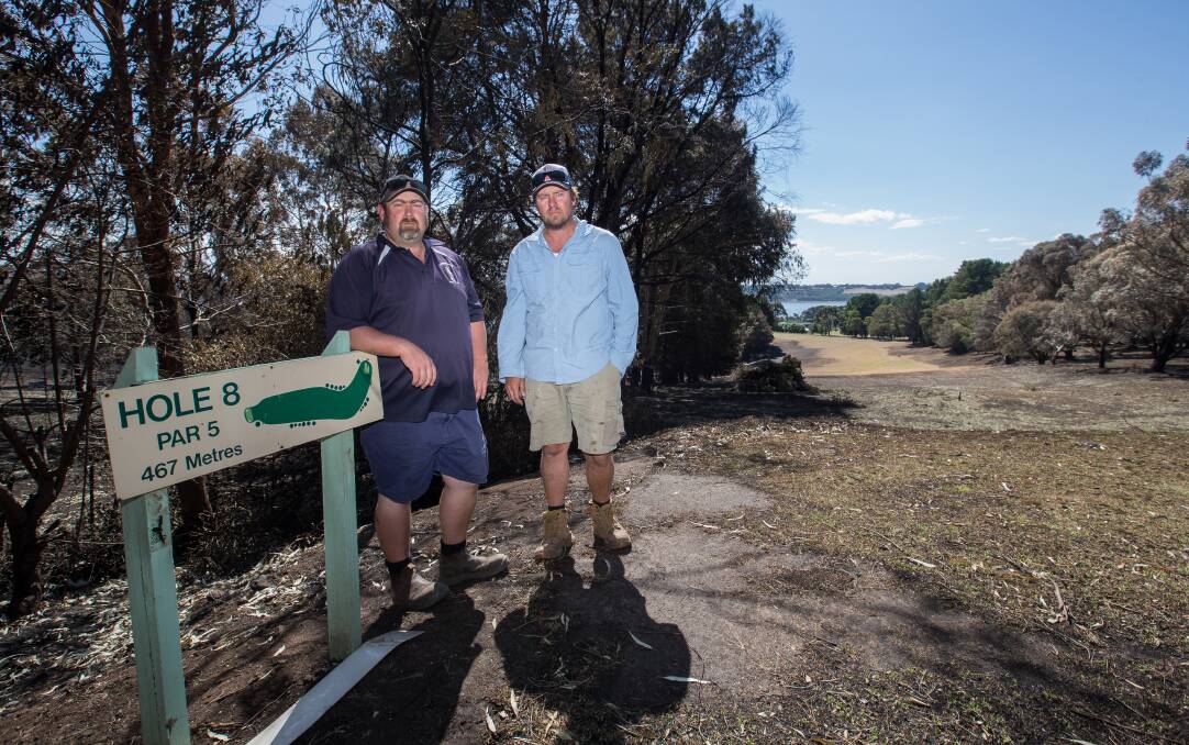 DAMAGED: Camperdown Golf Club captain Ricky Bailey and greens keeper Darren Fox stand at the fire ravaged eighth hole after the St Patrick's Day bushfires. The hole is now fit for play. Picture: Christine Ansorge