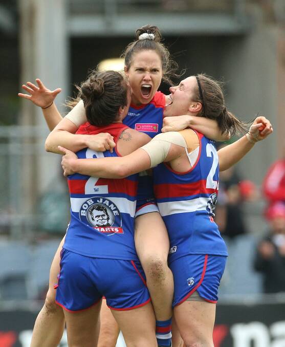 Ultimate success: Emma Kearney celebrates a last-quarter goal with Western Bulldogs teammates in the 2018 AFLW grand final over Brisbane. Picture: AAP/Hamish Blair