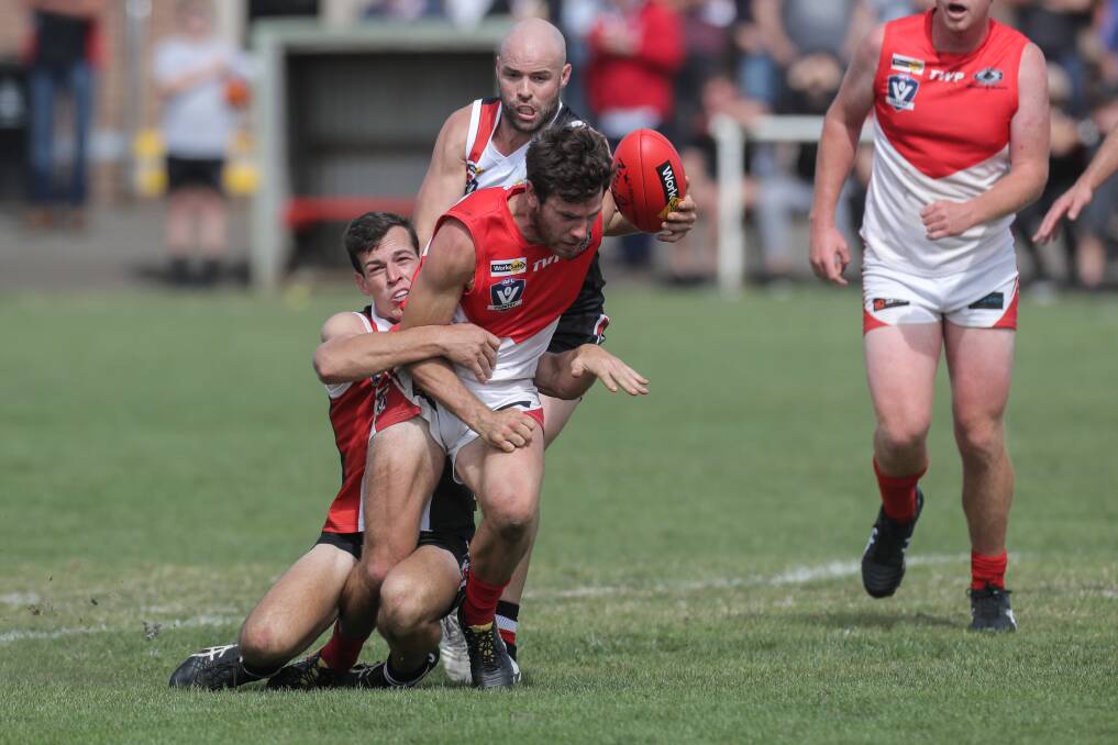 Injured: Koroit's Taylor McKenry, pictured tackling South's James Hussey, will miss Saturday's preliminary final. Picture: Rob Gunstone
