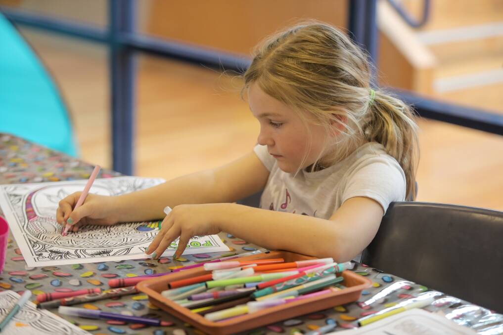 ARTISTIC: Indi Moloney, 7, concentrates on her colouring in with plenty of tools to chose from. Picture: Rob Gunstone