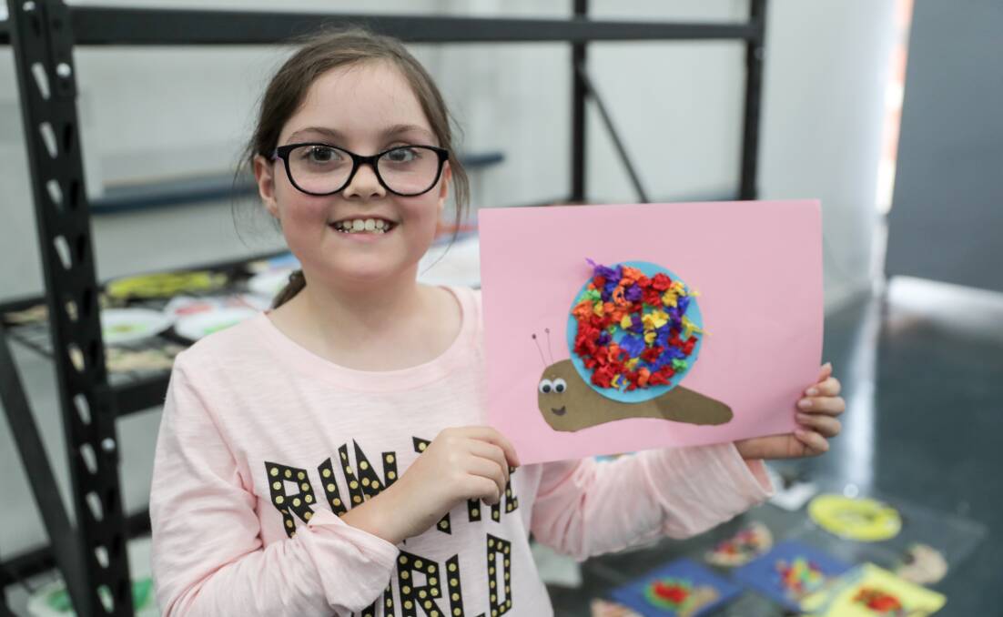 MOVING ALONG: Faith Diss, 8, with a colourful snail she created on Monday at Warrnambool Stadium. Picture: Rob Gunstone