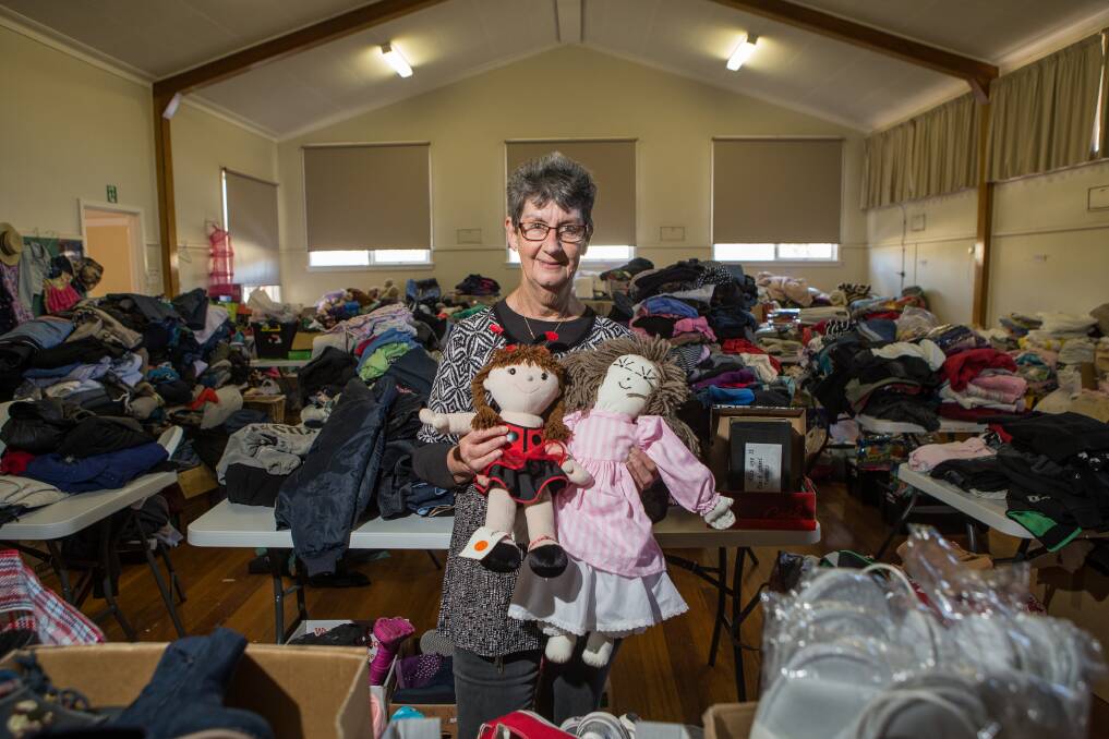 Volunteer Barb Cowley among the piles of donated clothes at the Cobden Uniting Church. Picture: Christine Ansorge